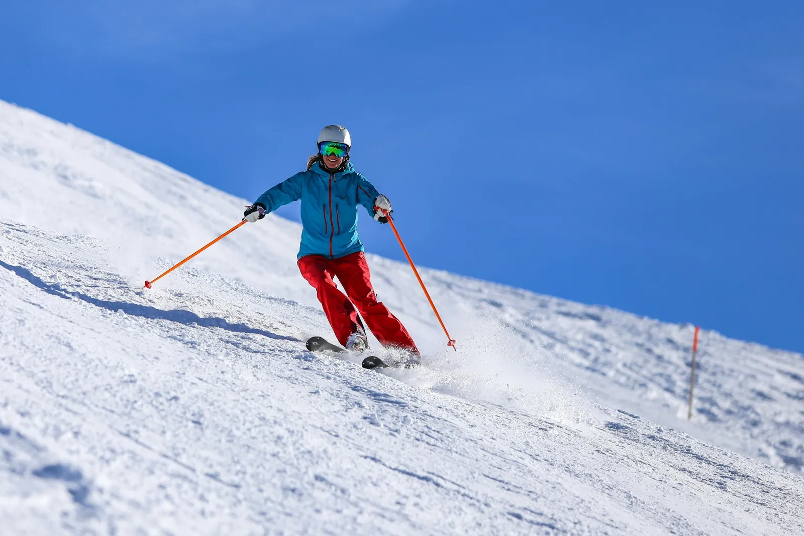 Skier carving on a groomed run