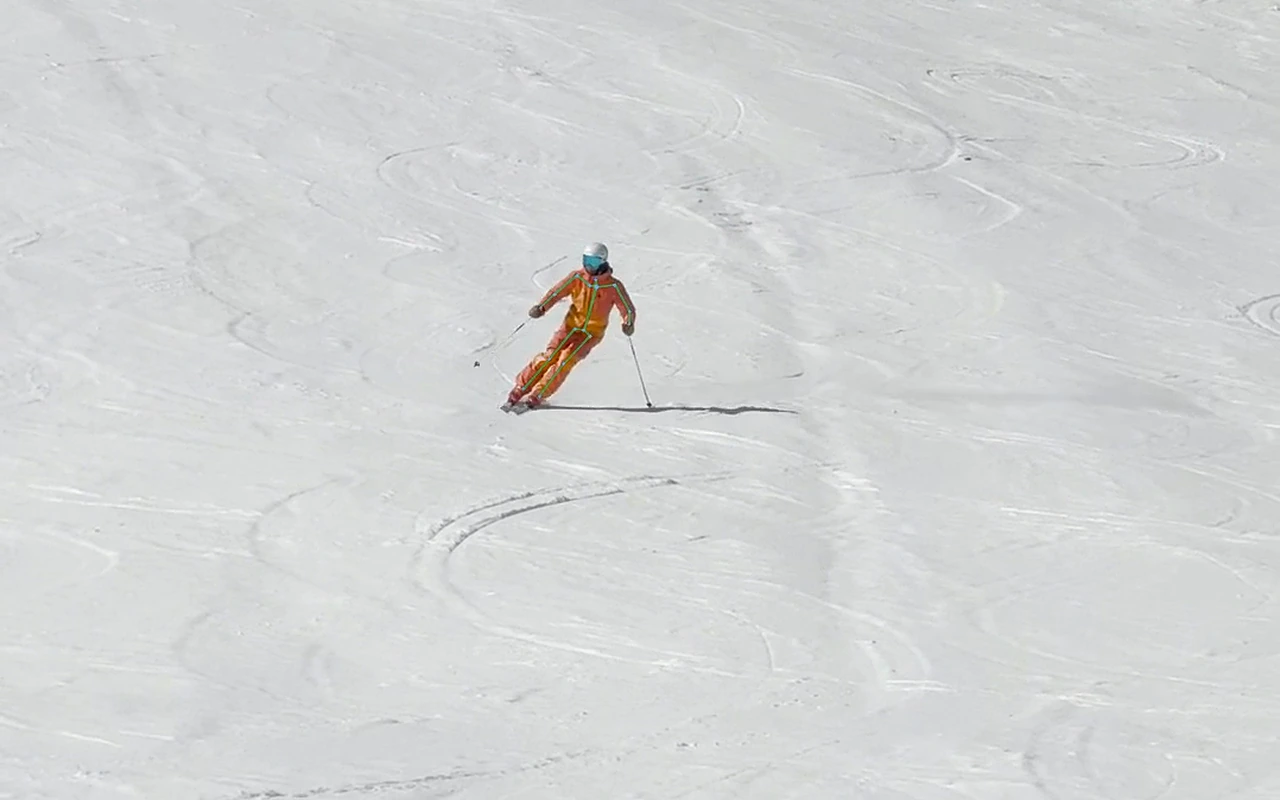 Skeleton overlay highlighting the skier's lower legs and skis during a turn